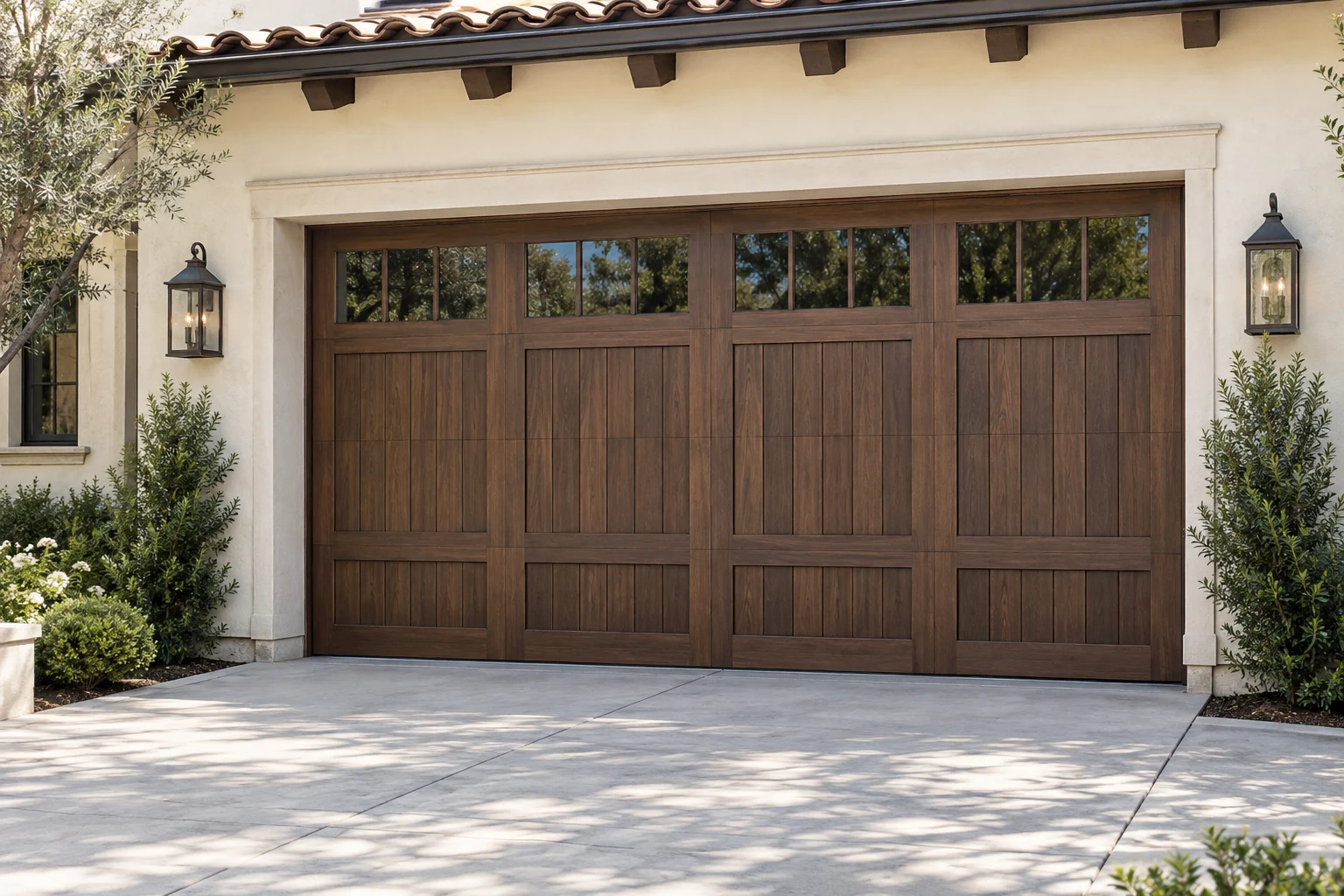 Walnut paneled garage door on a cream stucco home in daylight