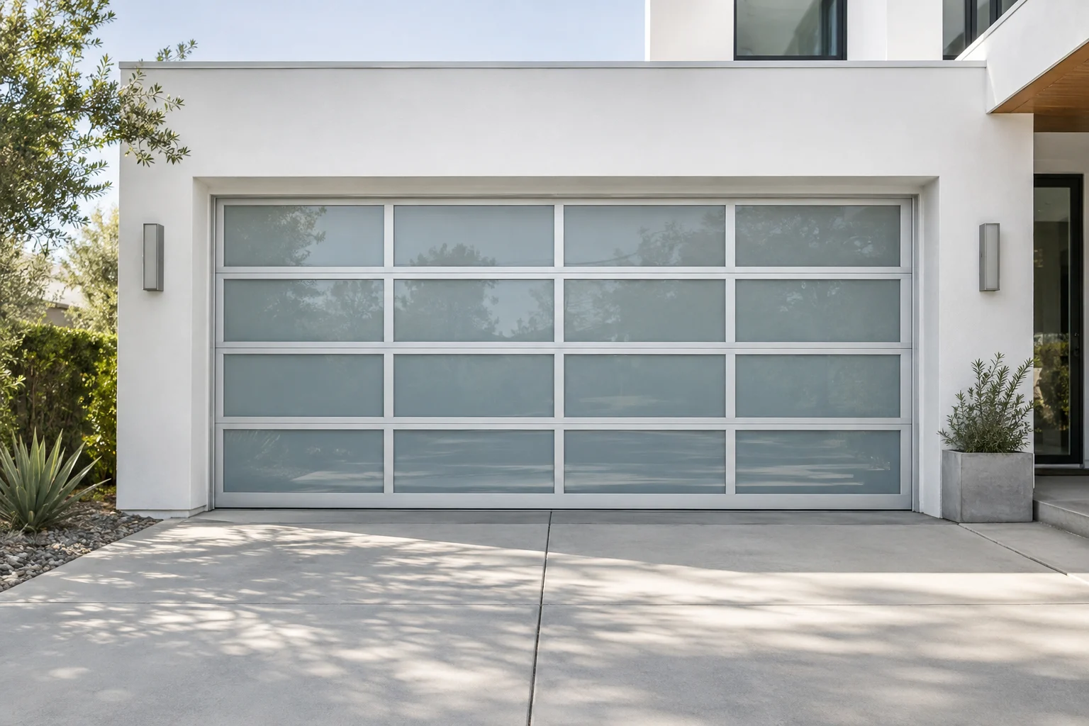 Bright frosted-glass garage door on a contemporary white home in daylight
